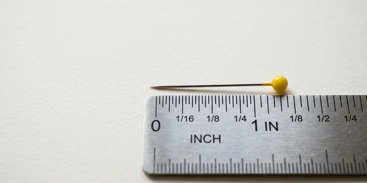 Sewing pin next to a steel ruler, measuring ~1 in (26 mm)