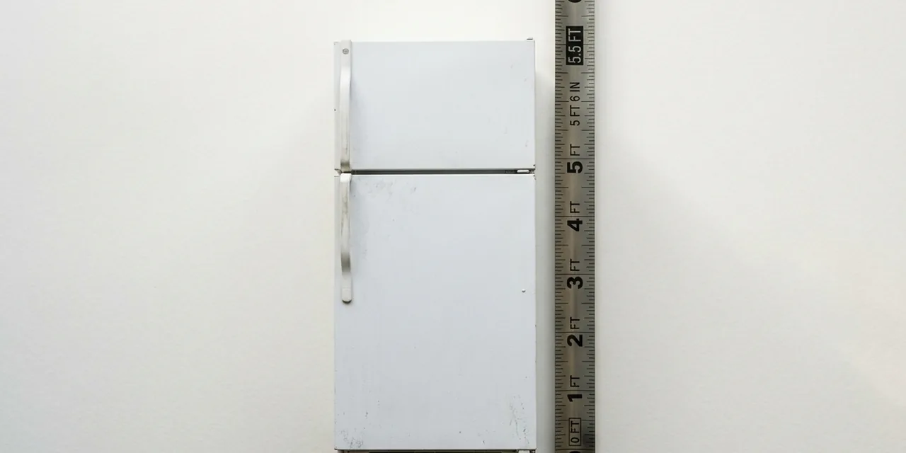 Refrigerator next to a steel ruler, measuring ~5.5 ft (168 cm)